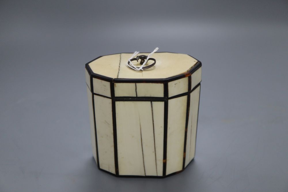 A George III octagonal ivory and tortoiseshell veneered tea caddy, height 10cm